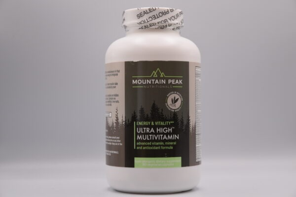 A sealed bottle of Mountain Peak Nutritionals - Ultra High multivitamin supplement with a label describing it as an advanced vitamin, mineral, and antioxidant formula, against a neutral background.