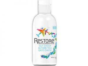 A bottle of Ion Gut Health / Restore - 8oz dietary supplement with colorful abstract design and the text "gut check before you gate check" indicating a product intended for gut health support.