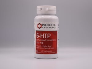A bottle of Protocol For Life Balance - 5-htp 200 mg dietary supplements with a tagline "supports a positive mood" displayed prominently, featuring 60 veg capsules.