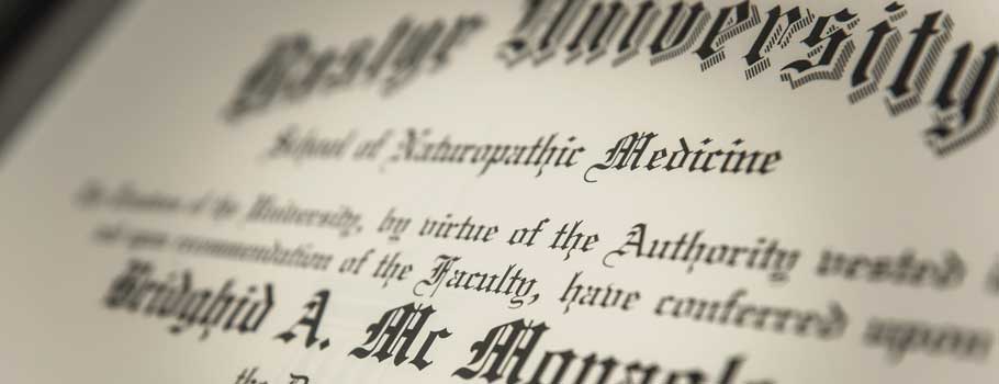 Close-up of an academic degree certificate from a university, focusing on the text which includes the school name and the phrase "school of naturopathic medicine.