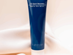 O3 Sport Recovery bottle resting on peachy silk fabric, combining softness and strength to reflect post-activity recovery and rejuvenation."