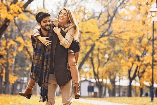 Smiling man giving a woman a piggyback ride, highlighting joy, energy, and wellness at Lake Oswego Health Center, a naturopathic and integrative medicine clinic in Oregon