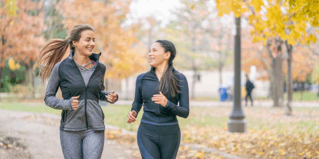 Smiling women running together, highlighting wellness and integrative medicine at Lake Oswego Health Center.
