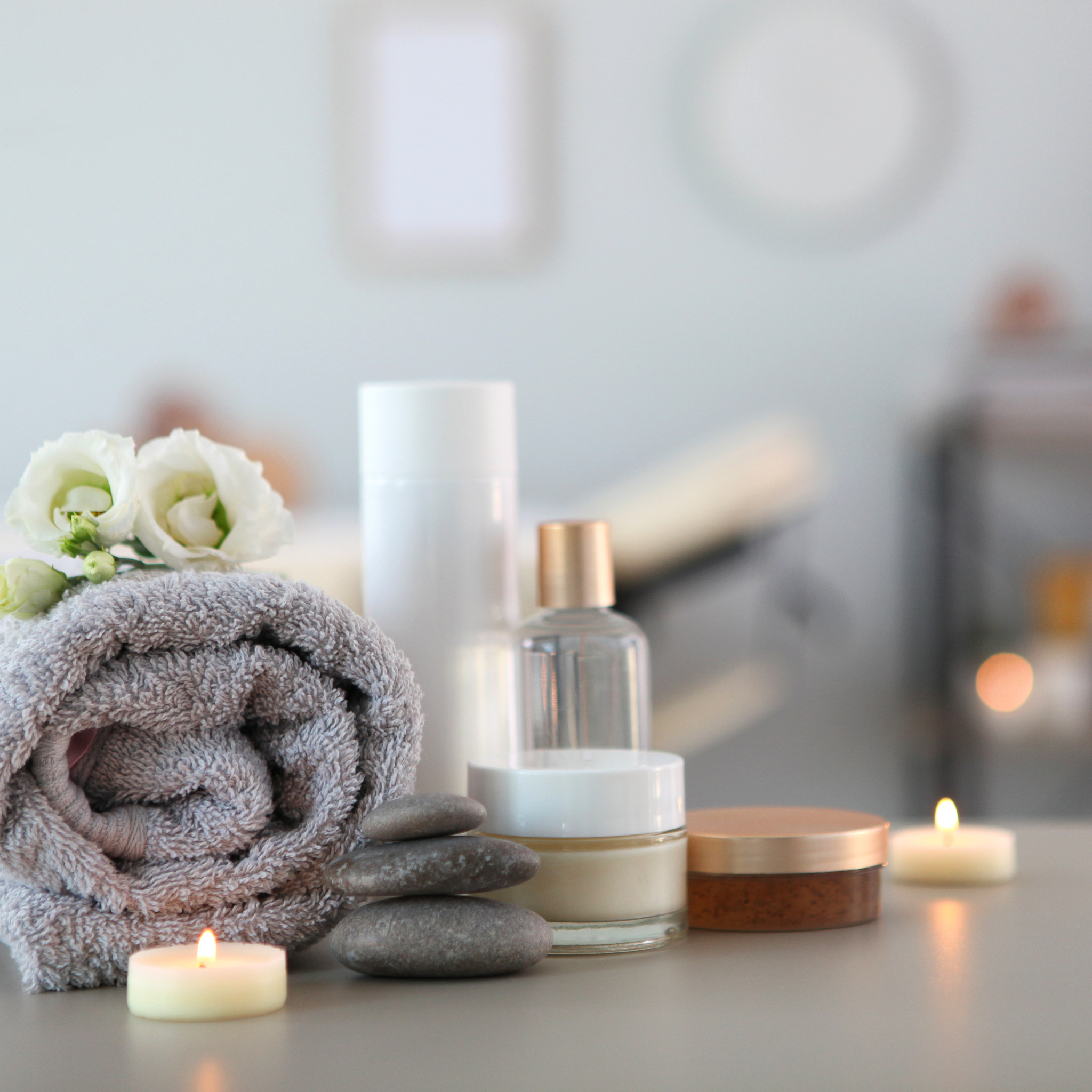 Spa ambiance with candles, towels, and skincare products at Modern Radiance Oregon spa.