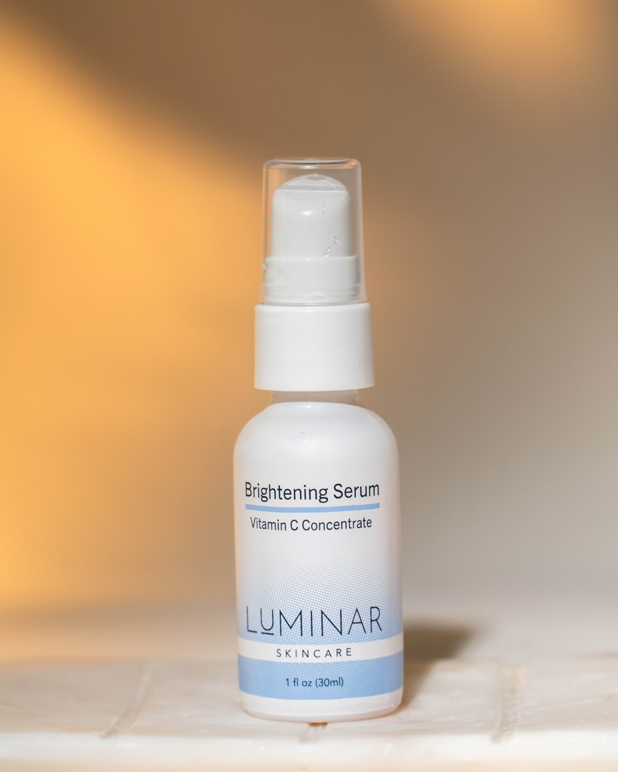 Brightening serum aganist a soft light background.
